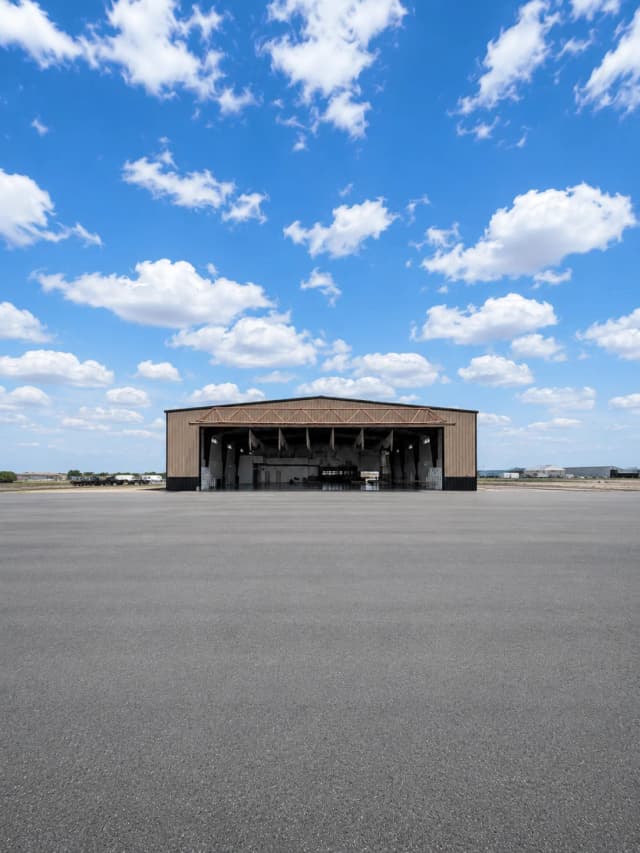 Exterior of the finished Vertical Venues hangar with the bay door open